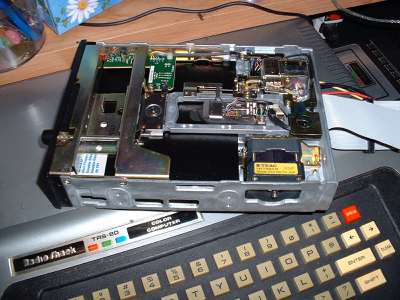 Tandy TRS-80 Color Computer with an bare 5.25” floppy rive